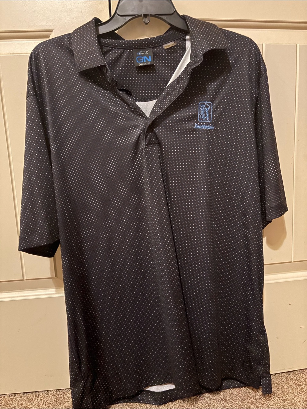 Greg Norman Collection Black Polo with Light Blue TPC Scottsdale logo